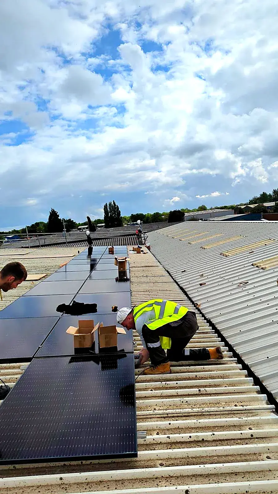 Installer fixing mounting rails on a roof