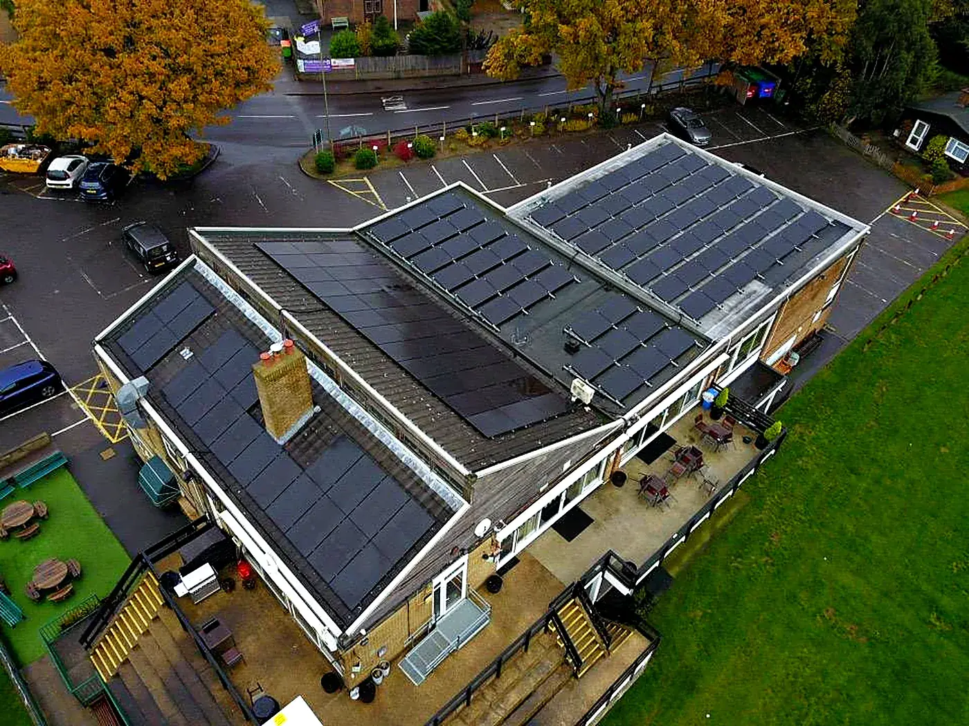 Aerial view of solar panels across a clubhouse roof